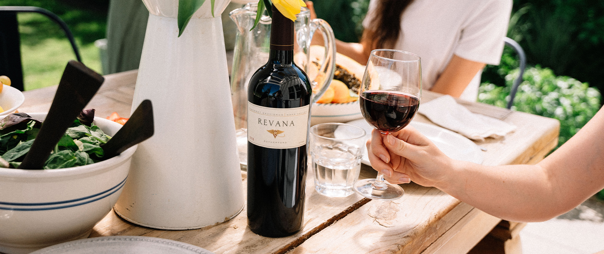 Revana Wine on a table with people
